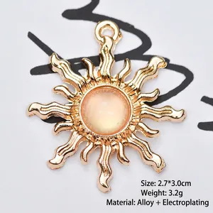 Detailed view of a golden sun flower pendant with orange stone for DIY jewelry making