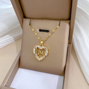 Luxurious gold heart LOVE necklace with sparkling crystals in an elegant jewelry box