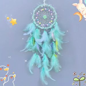 Mint green dreamcatcher wall decor with soft feathers and colorful beads for kids rooms