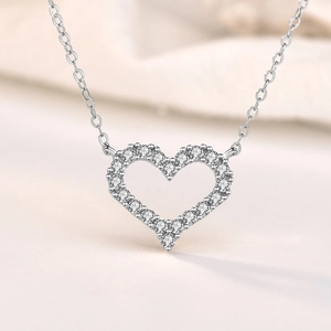 S925 sterling silver hollow heart necklace with sparkling crystals on a soft background