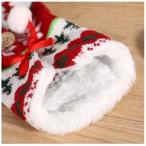 Close-up of knitted Christmas wine bottle cover with soft white faux fur lining and red ribbon
