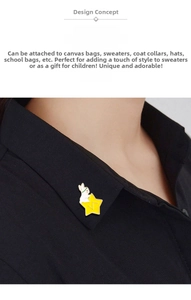 Detail shot of a rabbit and star enamel brooch pinned to a black shirt collar