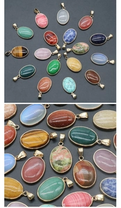 Macro view of various colorful oval gemstone pendants with golden metal settings