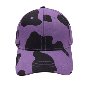 Purple cow print baseball cap with black spots and a pre-curved brim for sun protection