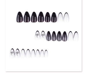 Detail of 24pcs long almond press-on nails with black bows and silver glitter accents
