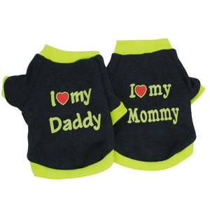 Detail of two black dog vests with fluorescent green trim and parental slogans