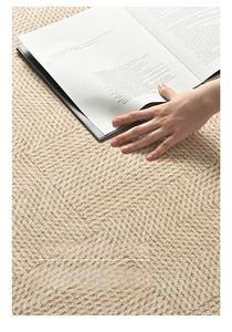 Detailed close-up of premium woven beige rug texture with soft textured fabric surface