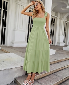 Detailed view of the sage green tiered maxi dress with ruched bodice and tie-straps
