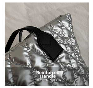 Detail showing quilted silver metallic rhombic texture and reinforced black leather handle