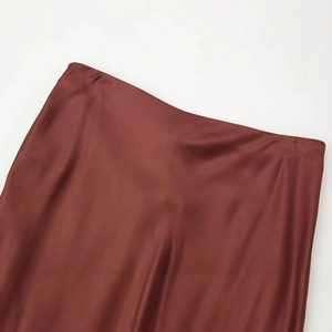 Lustrous brown satin skirt featuring a smooth silk texture and clean waist design