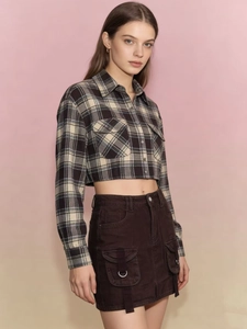 Detail shot of a dark brown utility cargo skirt with large pockets and metal ring accents