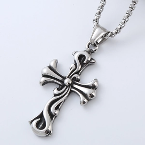 Close-up of silver titanium steel cross pendant necklace with gothic floral engraving