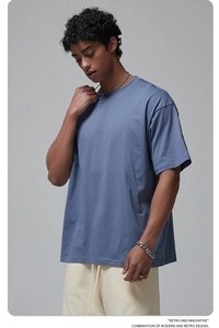 Detail of greyish blue oversized cotton t-shirt showing soft fabric texture and drop shoulder