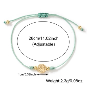 Adjustable mint green woven bracelet with gold Saint Benedict religious coin pendant