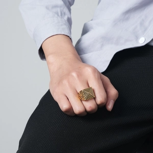 Detail of gold stainless steel Egyptian pyramid ring with Eye of Horus on model hand