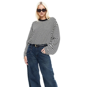 Detailed view of long-sleeved striped top with crew neck and black and white pattern