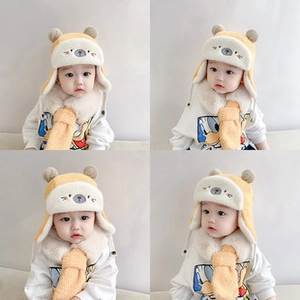 Detail of baby plush bear hat and scarf set in beige fleece for autumn and winter