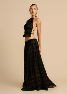 Detail of black halter backless crop top and tiered chiffon maxi skirt two-piece set