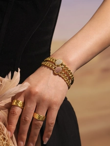 Detail of hip hop Cuban link bracelet set with pink zircon buckle and gold carved rings