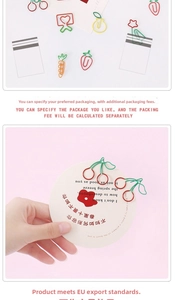 Close-up of colorful fruit-shaped paper clips including strawberry and carrot designs