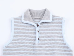 Detailed view of the polo collar and brown buttons on a striped knit sweater vest