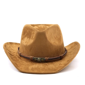Detail of suede vintage jazz hat with wide curved brim and metal skull ornament