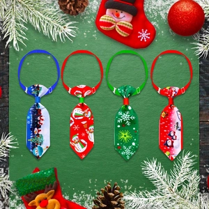 Christmas pet neckties set with festive patterns and adjustable elastic cords on green background