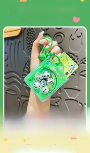 Close-up of green panda fishing game keychain with magnetic toy balls and bell charm