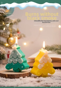 Detail of green and yellow Christmas tree candles with star toppers in a festive setting