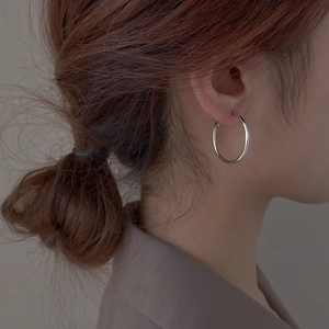 Minimalist silver hoop earrings for women featuring a classic polished metallic finish