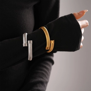 Modern gold and silver spiral spring open bangles in stainless steel on wrist