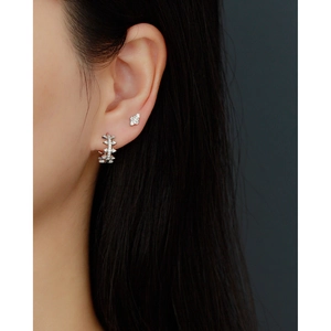 Close-up of S925 sterling silver geometric stud earrings with CZ stones on model