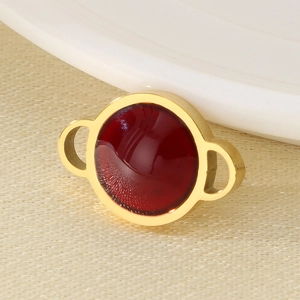 Detailed close-up of a gold-plated round pendant with a ruby red gem for DIY jewelry