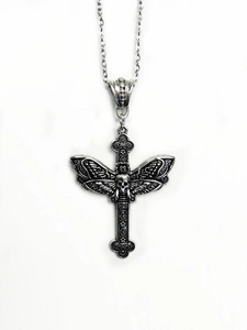 Detail of vintage silver gothic cross pendant with intricate skull and wing design