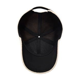 Internal view of beige faux fur baseball cap with black lining and adjustable strap