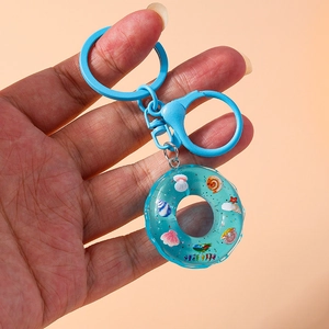Ocean theme blue lifebuoy keychain with shells and glitter held by model
