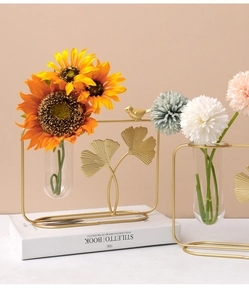 Detailed golden ginkgo leaf metal frame with a glass test tube hydroponic flower vase