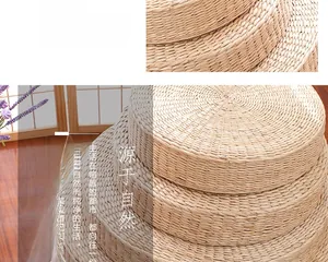 Detail of hand-woven natural straw round pouf cushions showing thick organic texture