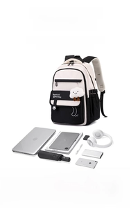 Detail view of large capacity black and white backpack showing interior storage for laptop and iPad
