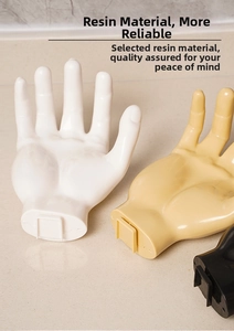Detailed view of hand-shaped wall hooks in white, beige and black resin material