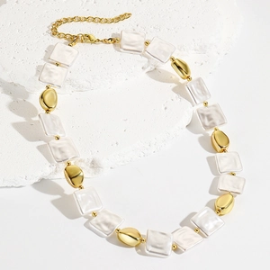 Detail of square shell beads and gold oval metal beads on a vintage layered necklace