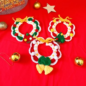 Detailed close-up of handmade crochet Christmas pet collars with festive bells and tree decor