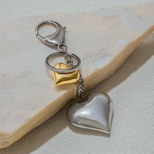 Close-up of heart-shaped metal charms on a stainless steel keychain accessory