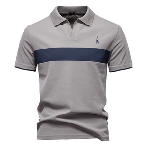 Close-up of grey cotton polo shirt featuring navy stripes and deer embroidery detail