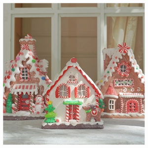 Macro detail of three clay gingerbread houses with sugar-like coating and festive colors