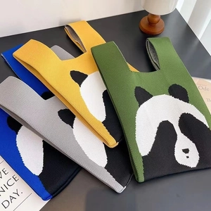 Close-up of knit panda tote bags in blue, yellow, grey and green textured fabric