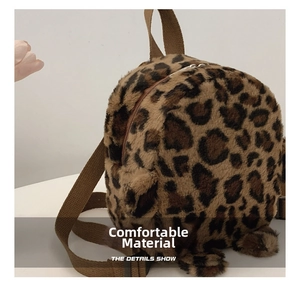 Detailed side view of mini leopard print plush backpack featuring cute soft paws