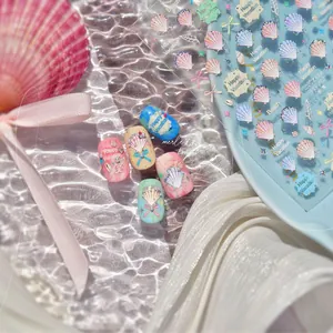 Detail of seashell embossed nail stickers with gold foil and 3D beach vacation elements