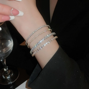Detail of elegant gold and silver tennis bracelets with micro-pave cubic zirconia crystals