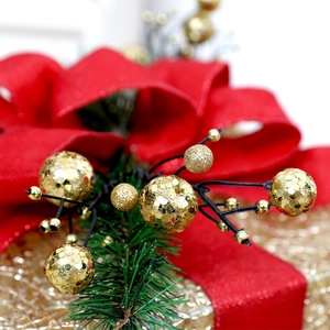 Macro detail of Christmas box decor with gold glitter berries and green pine needles